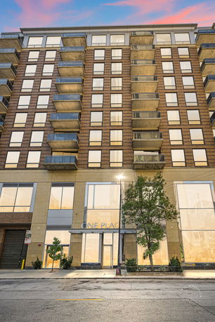 Front view of a multi-story building with balconies.