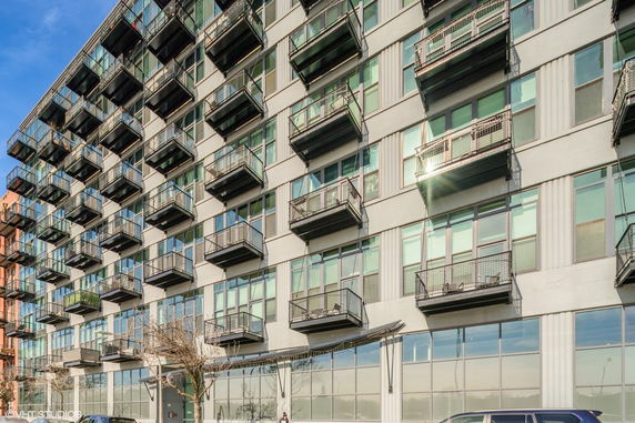 Front view of a multi-story building with multiple balconies.