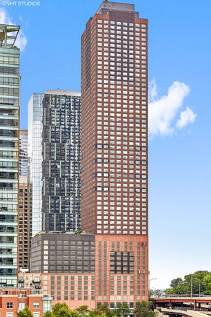 Front view of a tall, multi-story building with a distinctive grid-like window pattern.