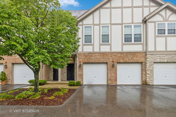 Front elevation of a two-story townhouse with a double garage.