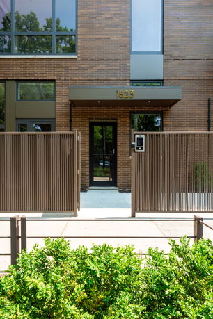 Front view of a modern building with a gated entrance.