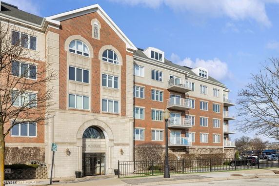 Front view of a multi-story building with brick and stone exterior.