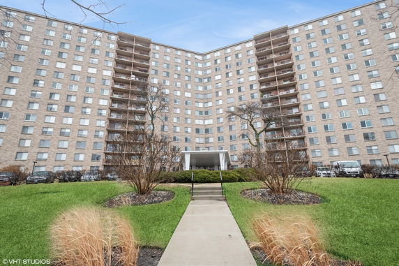 Front view of a multi-story residential building with balconies.