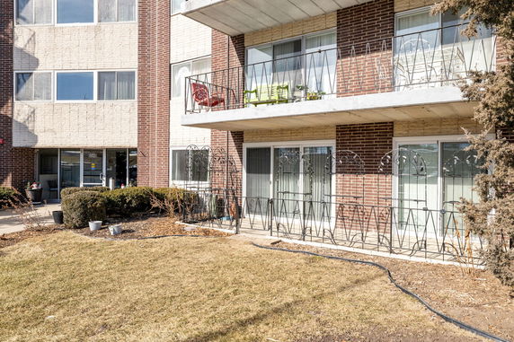 Front view of a multi-story brick building with balconies.