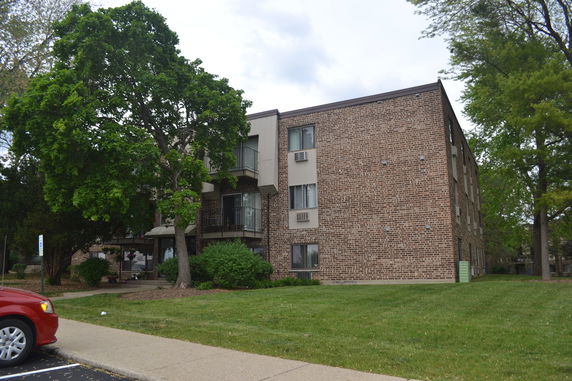 Front view of a multi-story brick apartment building.