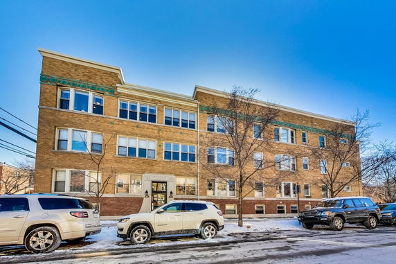 Front view of a three-story brick apartment building.