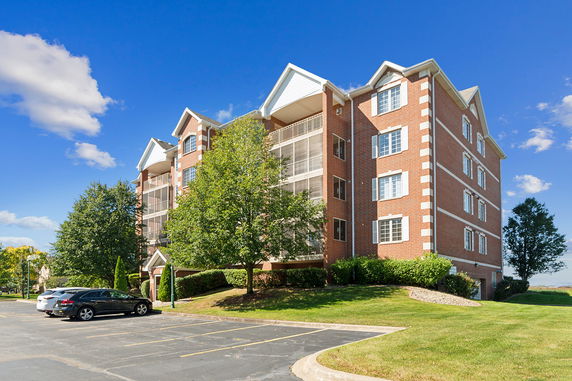 Front view of a multi-story brick apartment building.