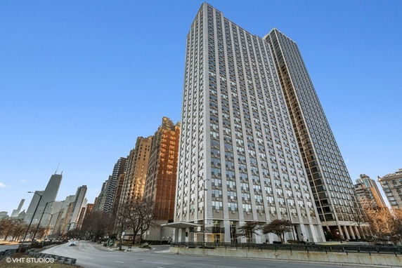 Front view of a tall skyscraper with multiple floors and glass windows.