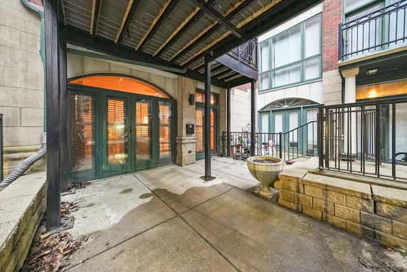 Rear view of a building with large glass doors and balconies.