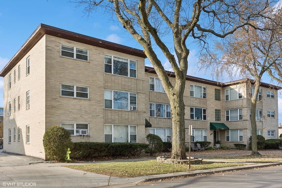 Front view of a three-story brick apartment building.