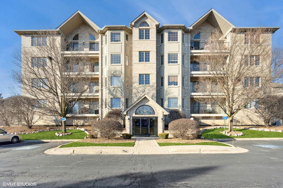 Front view of a multi-story residential building with a central entrance.