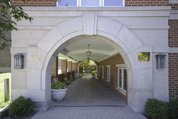 Front view of an arched entrance to a brick building.