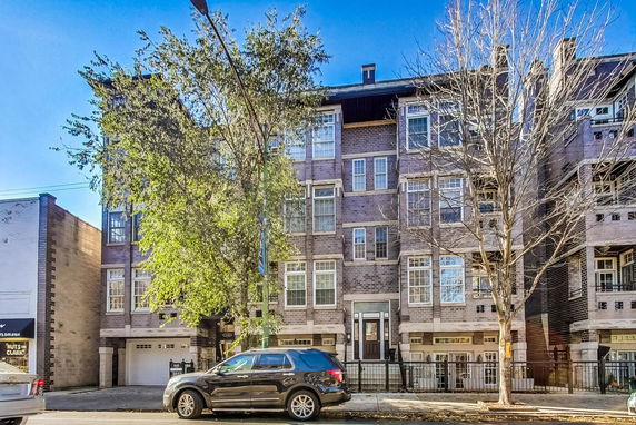 Front view of a multi-story brick apartment building.