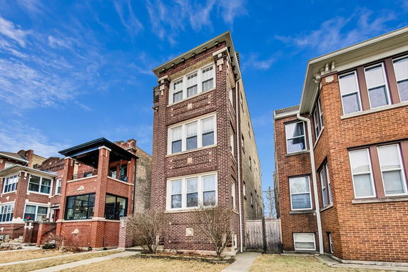 Front view of a multi-story brick residential building.