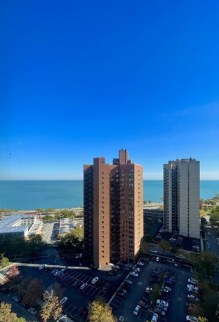 High-rise buildings with a view of a large body of water in the background.