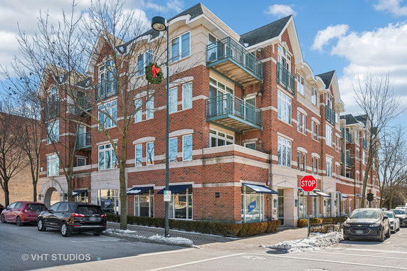Front view of a multi-story brick building with balconies.