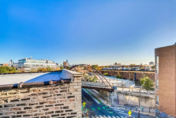 Panoramic view of urban skyline and city infrastructure from a rooftop.