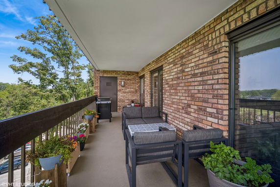 Balcony with outdoor seating and railing view.