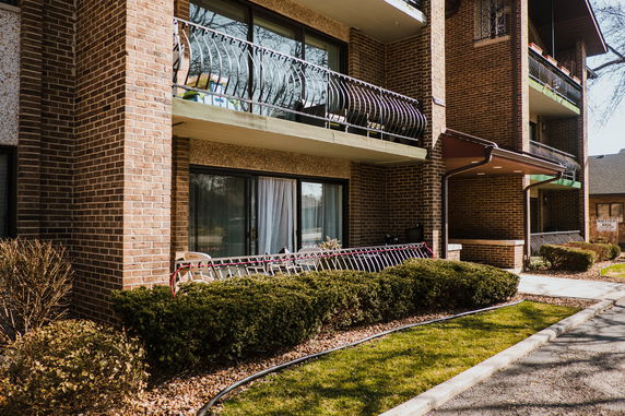 Front view of a multi-story brick building with balconies.