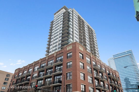 Front view of a multi-story residential building with balconies.
