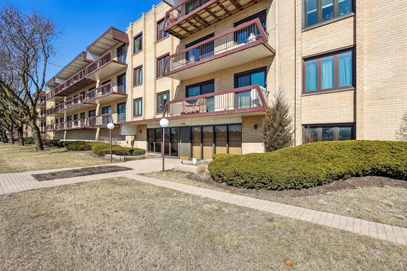 Front view of a multi-story residential building with balconies.