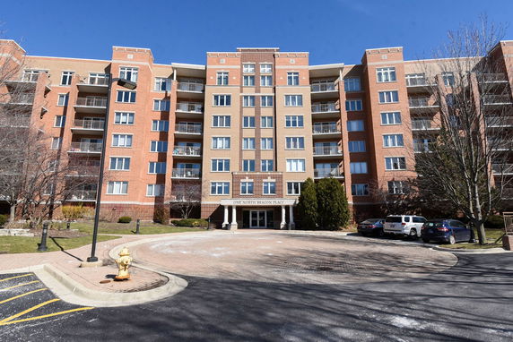Front view of a multi-story residential building with balconies.