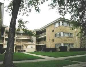 Front view of a multi-story apartment building with balconies.