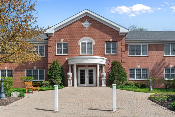 Front view of a two-story brick building with a central entrance.