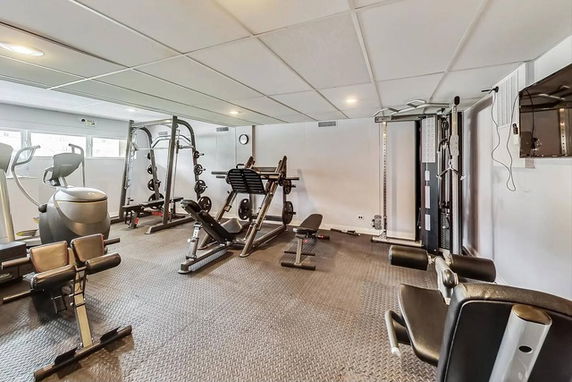 Interior view of a fitness room with various gym equipment.