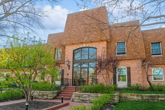 Front view of a building with large windows and sloped roof.