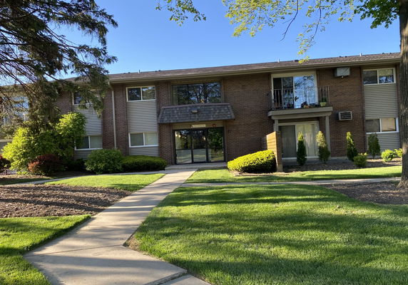 Front view of a two-story brick apartment building.