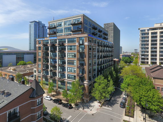 Front view of a multi-story residential building with balconies.