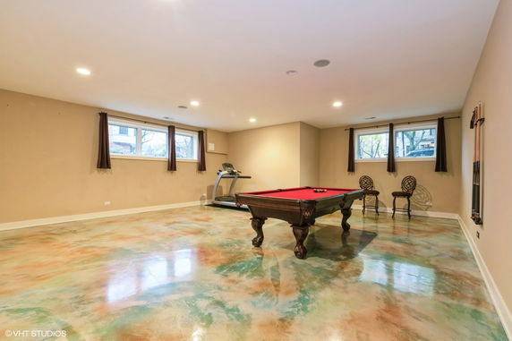 Indoor recreation room with pool table and treadmill