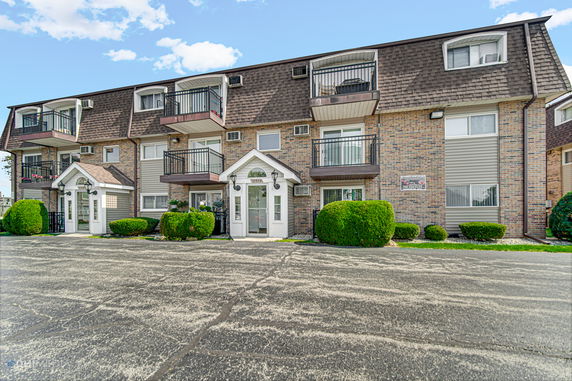 Front view of a multi-story building with balconies.