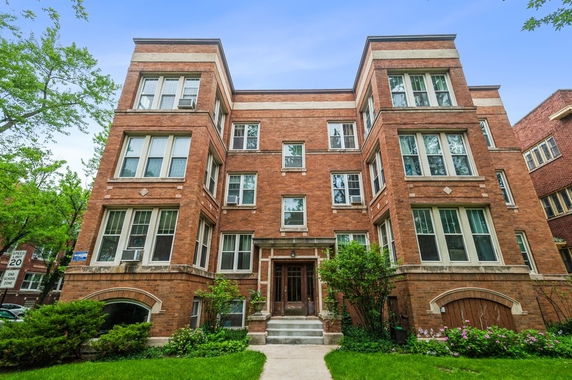 Front view of a multi-story brick apartment building.