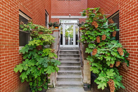 Staircase leading to an entrance of a brick building.