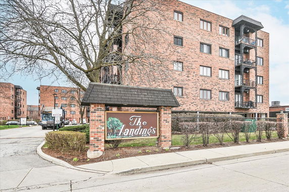 Front view of a multi-story brick building with a sign reading 'The Landings.'