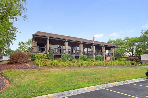 Front view of a building with a covered porch and pillars.