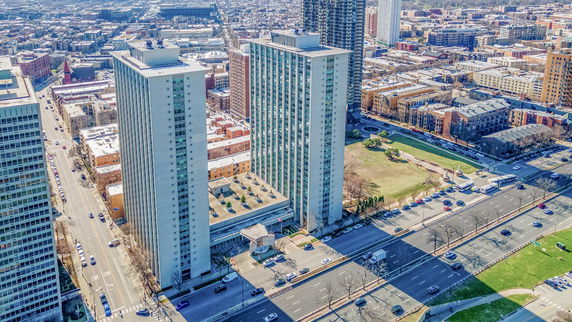 Elevated view of two high-rise residential buildings in an urban area.