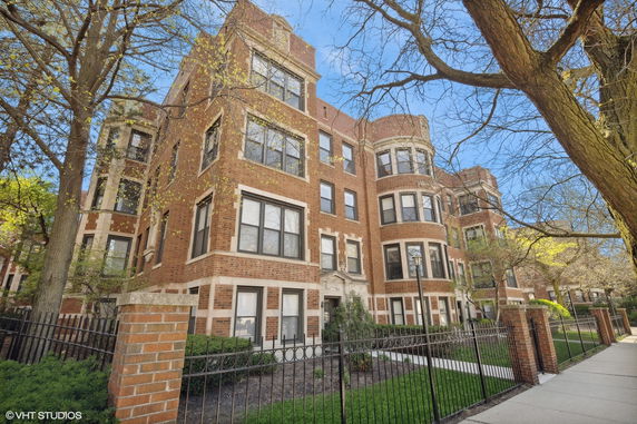 Front view of a multi-story brick apartment building.