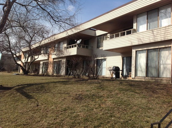 Front view of a two-story building with balconies.