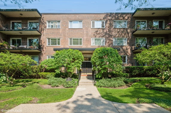 Front view of a three-story apartment building with brick exterior.