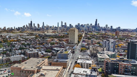 Wide-angle view of a cityscape with numerous buildings and skyscrapers.