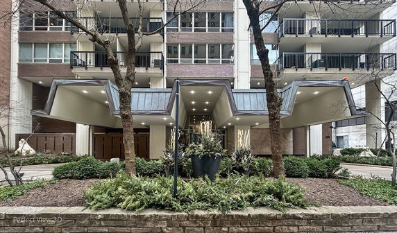 Front view of a multi-story building with distinctive roof design.