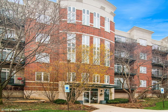 Front view of a multi-story brick apartment building.