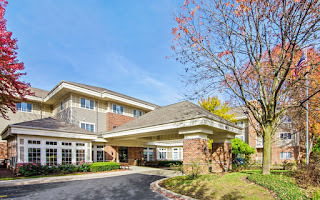 Front view of a multi-story building with a covered entryway.