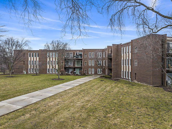 Front view of a multi-story brick residential building.