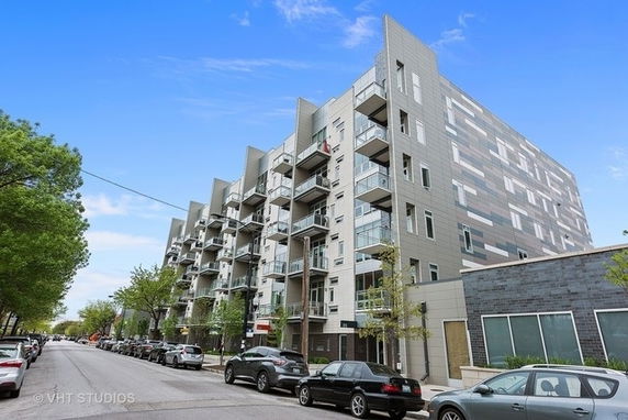 Front view of a multi-story apartment building with balconies.