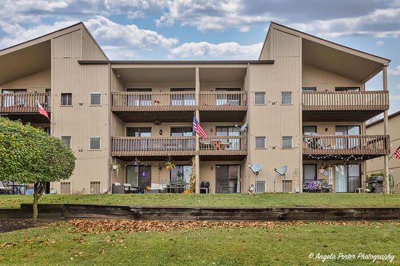 Front view of a multi-story residential building with balconies.