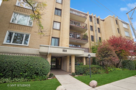Front view of a multi-story apartment building with balconies.